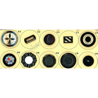 A small card of division one black glass buttons