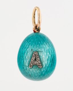 [FABERGE] A MINIATURE EGG PENDANT IN TURQUOISE BLUE GUILLOCHE ENAMEL WITH A DIAMOND ENCRUSTED INITIAL, PARTIALLY LEGIBLE HALL