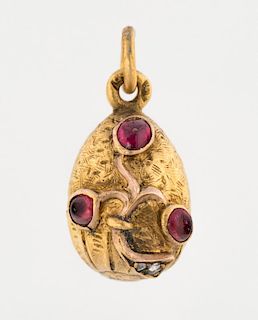 [FABERGE] A MINIATURE GOLD EGG PENDANT WITH RED GEMS, MARKED AT