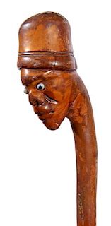 306. Man Folk-Art Cane – Ca. 1880 – A carved one-piece natural branch shaft with a carved burl of a gentleman in a tall h