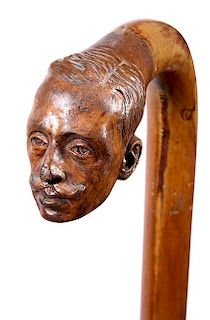 359. Folk-Art Portrait Cane – Ca. 1930 – A malacca shaft with a carved portrait attached of a gentleman which has the app