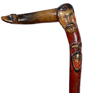 369. Patriotic Folk-Art Cane – Ca. 1890 – A stylized dog head cane handle with a gentleman and mustache and beard and ros