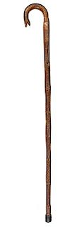 387. Snake Folk-Art Cane – Ca.1880 – An oak shaft with a stylized oak handle, carved ferns and branches throughout the tw