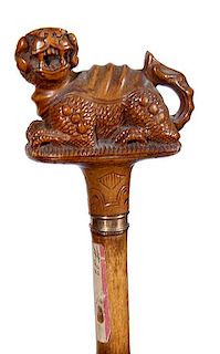 388. Chinese Carved Cane – Ca. 1860 – A carved full figure Chinese animal, small gold metal collar, bamboo shaft, and spl