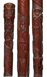 313. Military Folk-Art Cane – Ca. 1890 – A carved one-piece cane with various military subjects including: a sailor holdi