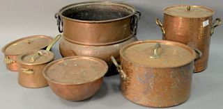 Seven copper pots to include three hand hammered pots with heavy brass handles. largest: ht. 12in., dia. 16in.