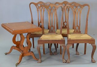 Five piece lot including Contemporary table with harp Duncan Phyfe style base and four Chippendale style rush seat chairs.
