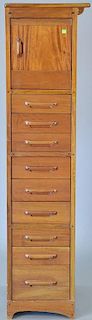Mahogany tall cabinet having one door over nine drawers. ht. 65in., wd. 16in.