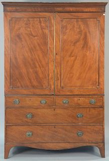 George IV mahogany linen press in two parts, two door cabinet with fitted drawer interior over three drawer base, circa 1800.