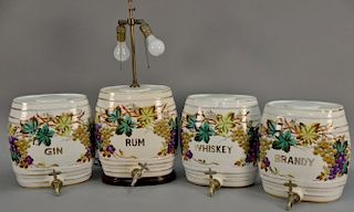 Set of four Victorian ceramic spirit barrels having grapevines and marked Brandy, Rum, Whiskey, and Gin; marked near bottom G