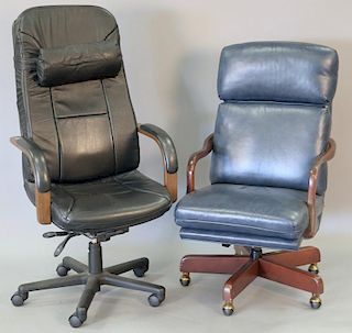 Two swivel office desk armchairs, one in blue leather and the other in black leather.
