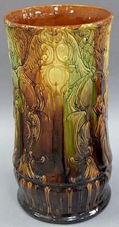 Majolica umbrella stand, green brown glazed with embossed flower design.