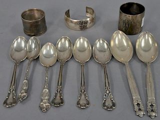 Sterling silver group to include pair of Georg Jensen sterling spoons, six miscellaneous spoons, two napkin rings, and a brac