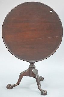 Chippendale style mahogany birdcage tip table having dish top over turned shaft and ball and claw feet. ht. 27in., dia. 30in.
