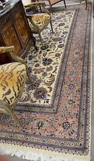 Room size contemporary carpet having cream ground with rose border, 10'1" x 14'2".