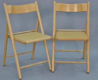 Set of eight maple folding chairs having caned seats.