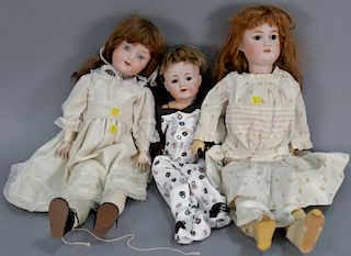 Three bisque head dolls including one marked Armand Marseille German 390 A7M, one marked G.B., and one small boy marked Simon