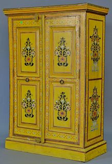 South American two door cabinet painted yellow with flowers and garlands. ht. 48in., wd. 32in.