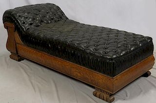 CARVED OAK AND LEATHER CHAISE LOUNGE EARLY 20TH C.