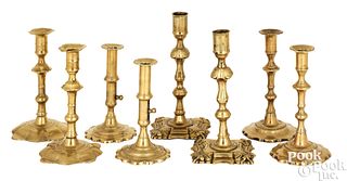 Four pairs of English brass candlesticks