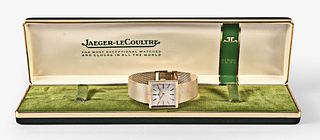 A mid 20th century LeCoultre gold wrist watch with boxes and papers