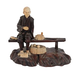 Japanese Wood Carving of a Man on a Bench
