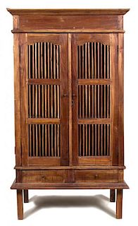 A Javanese Teak Two Door Cabinet Height 69 x width 39 x depth 24 inches.