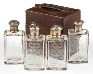 FRENCH 0.950 SILVER-MOUNTED ENGRAVED GLASS FOUR-PIECE BOTTLE SET IN ORIGINAL LEATHER CASE