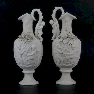 Pair of Victorian Style Bisque Porcelain Putti Figural Relief Ewers