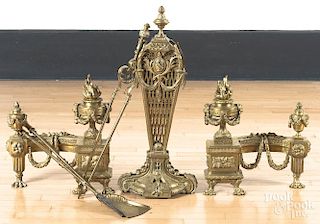French brass fireplace set, to include a pair of chenets, 17'' h., a fender, 8 1/2'' h., 53'' w., a fan