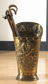 Embossed brass umbrella stand, together with five canes, 30'' h.