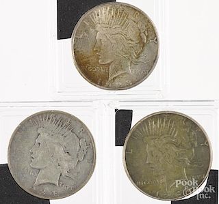 Three silver Peace dollars, to include 1923 S, 1934, and 1934 S.