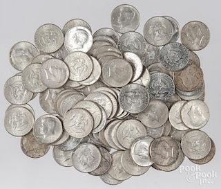 One hundred and seven Kennedy silver half dollars.