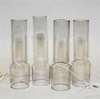 * A Group of Four Molded Glass Oil Lamp Chimneys Height of tallest 7 1/8 inches.