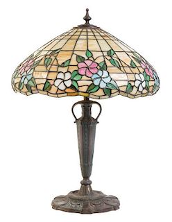 An American Leaded Glass and Bronze Lamp, THE MOSAIC SHADE COMPANY, CHICAGO, the shade having a floral pattern, raised on an 
