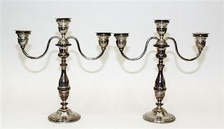 A Pair of American Silver Candlesticks, , having a central urn form cup and two conforming cups issuing S-scroll branches sur