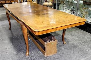 A Queen Anne Style Burlwood Dining Table Height 29 1/2 x width 66 x depth 41 1/2 inches.