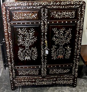 A Chinese Mother-of-Pearl Inlaid Hardwood Cabinet Height 40 x width 29 3/4 x depth 16 inches.