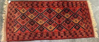 A Persian Style Wool Rug 6 feet 11 inches x 3 feet 2 inches.