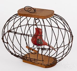 Folk art carved bird in cage, 6 1/2" h., 8" w.