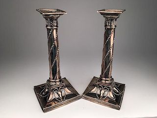 Pair of weighted sterling silver Empire style candlesticks.