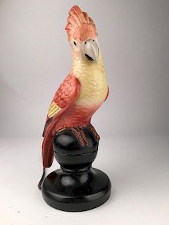An antique night light as a coc a too mounted on a wood base.<BR>Height 12 inches.