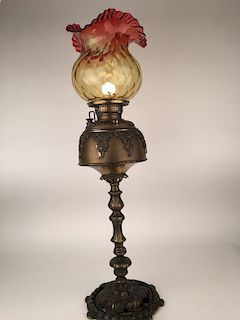 Antique parlor lamp with a cranberry glass scalloped shade.<BR>Converted from gas