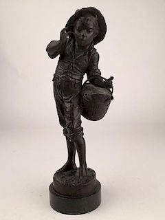 Bronze figure of a young boy smoking with a basket