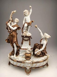 Porcelain figurine of two women and one putti all with flowers.<BR>Height 11 1/4 i