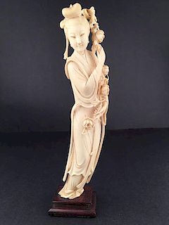 Antique carved standing beauty holding a bunch of flowers