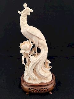 Antique carved peacock standing in leaves and flowers lookung back.<BR>Height of c