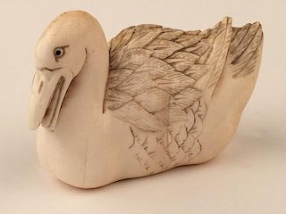 A carved Netsuke figure of a swan.<BR>Signed.<BR>Height 1 1/4 inches.