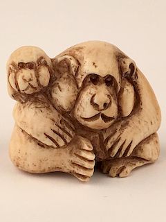A carved Netsuke figure of a large and small bear.