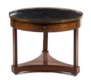 An Empire Style Mahogany Bouillotte Table Height 30 1/2 x diameter 38 3/8 inches.